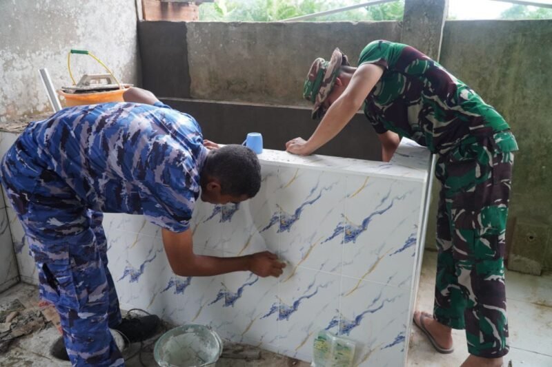 Satgas TMMD ke-126 Kodim 1208/Sambas Pasang Keramik Bak Air Tempat Wudhu Masjid Jamuatul Muslimin