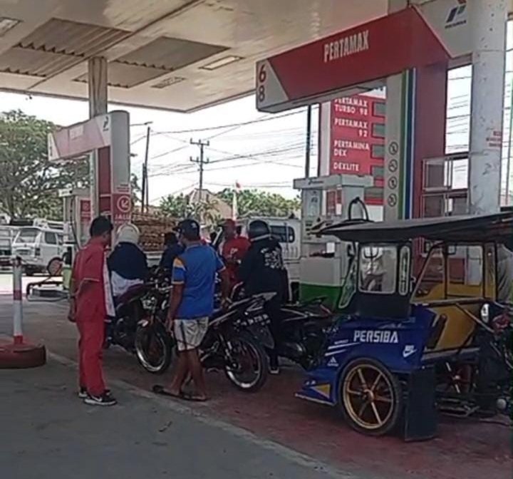 Aktivitas pengisian BBM di SPBU Isimo, Desa Tolotio, Kecamatan Tibawa, Kabupaten Gorontalo. Harga Pertalite eceran menggunakan botol air mineral disebut mencapai Rp20 ribu hingga Rp25 ribu per botol 1,5 liter.