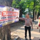 Foto: Petugas Satlantas Polres Pelabuhan Tanjung Perak bersama Satpam Pelindo memasang banner larangan parkir di sepanjang Jalan Perak Barat, Surabaya, Selasa (6/10/2026), sebagai upaya menjaga Kamseltibcarlantas.
